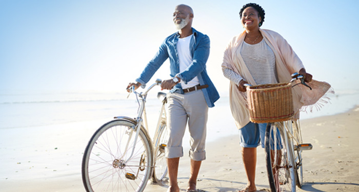 Senior couple on a beach with bikes